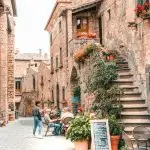 A medieval hilltop village of Civita di Bagnoregio perched on an eroding tufa cliff in central Italy, connected to the valley below by a narrow pedestrian bridge