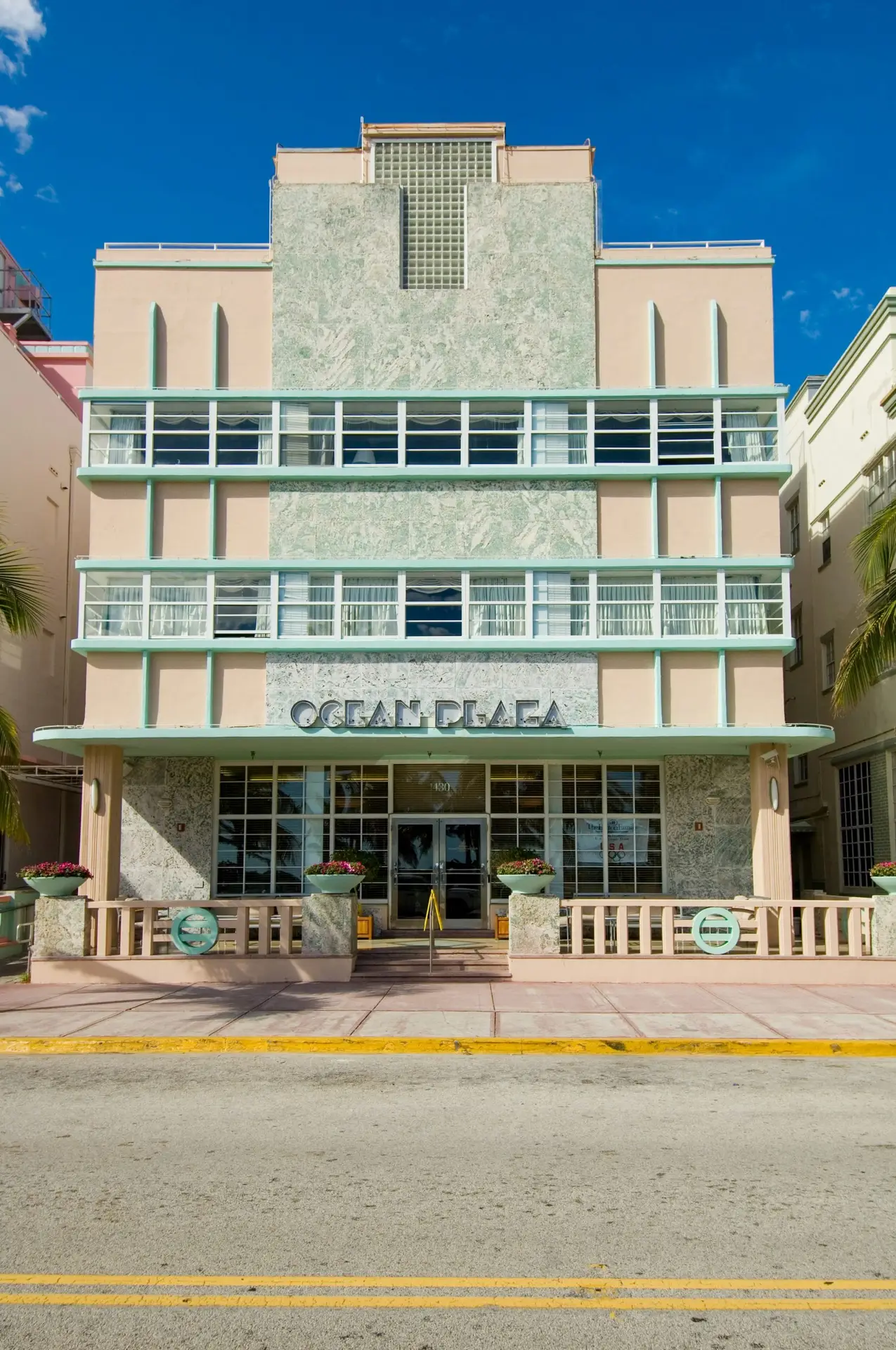  Ocean Plaza art deco hotel on Ocean Drive in Miami Beach with pastel pink facade and streamline horizontal windows