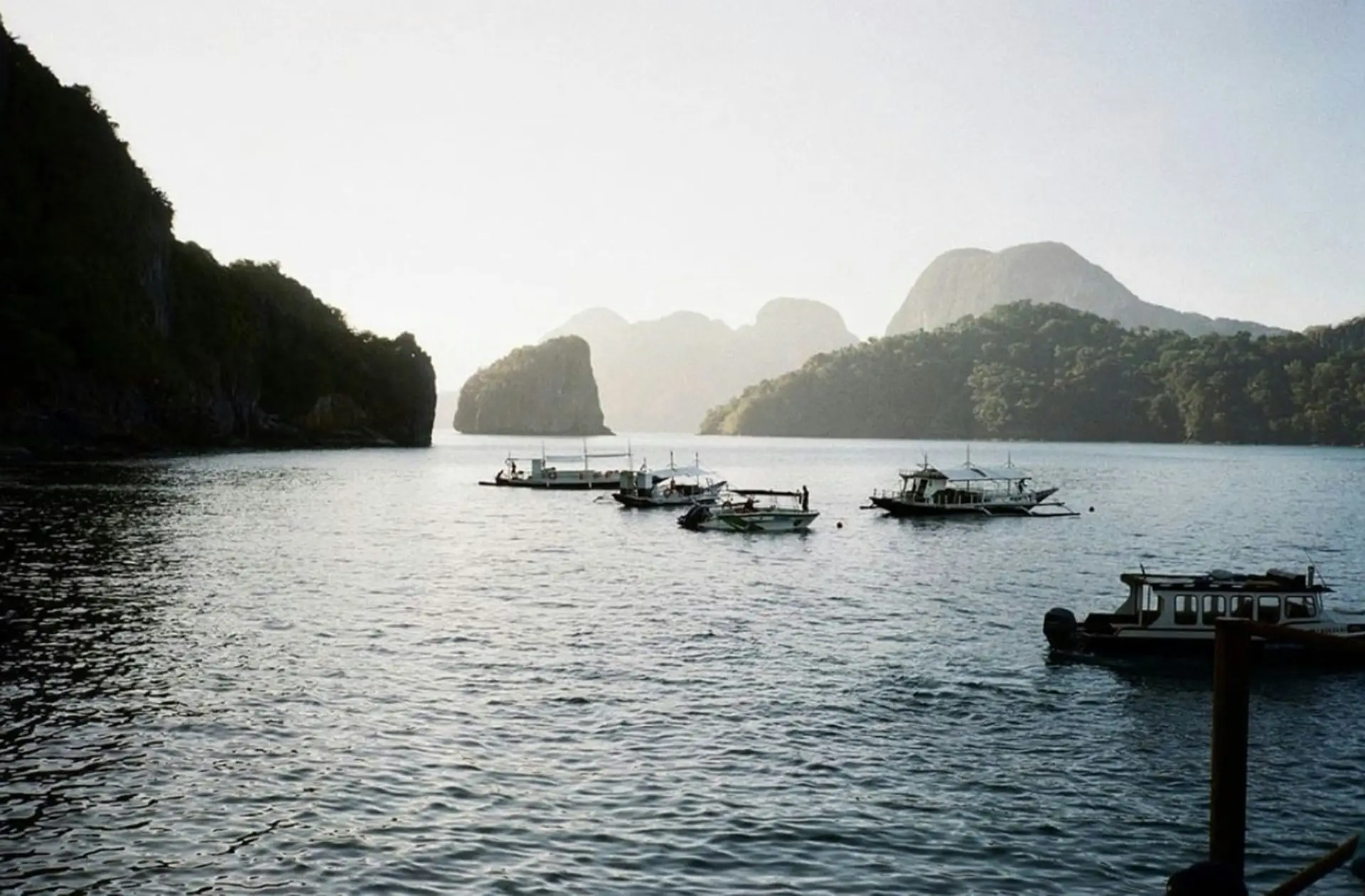 Cauayan Island review: bangka boats in Bacuit Bay at dawn, El Nido, Palawan
