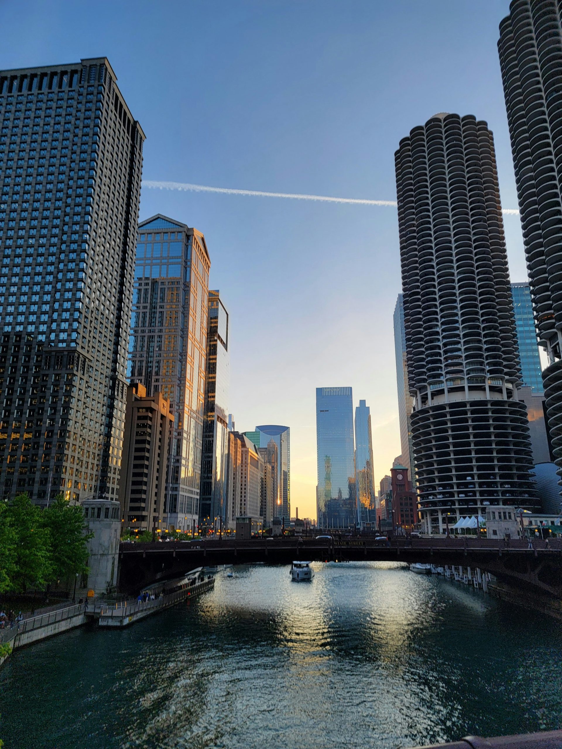 Chicago River at sunset with Marina City towers and skyscrapers, where the world's first skyscraper was born