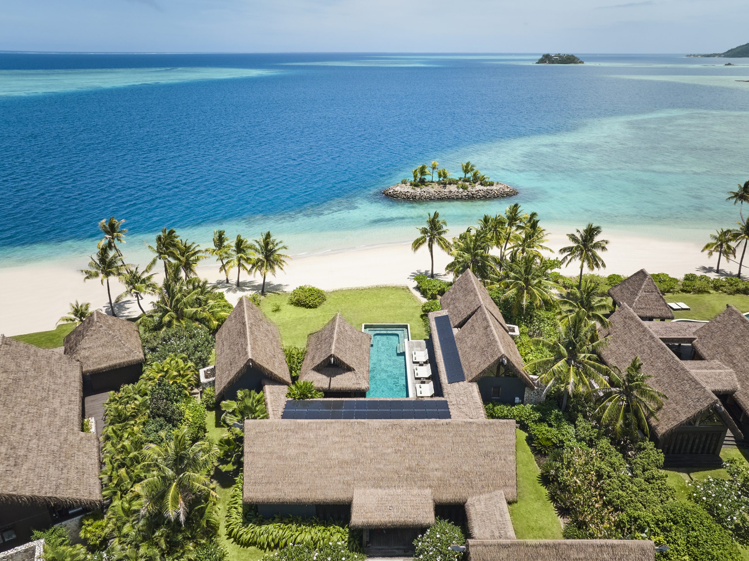 Six Senses Fiji Opens Three Beachfront Residences on Malolo Island 1 Aerial view of Six Senses Fiji Residences on Malolo Island, with thatched-roof bures, private pool, beachfront and turquoise lagoon