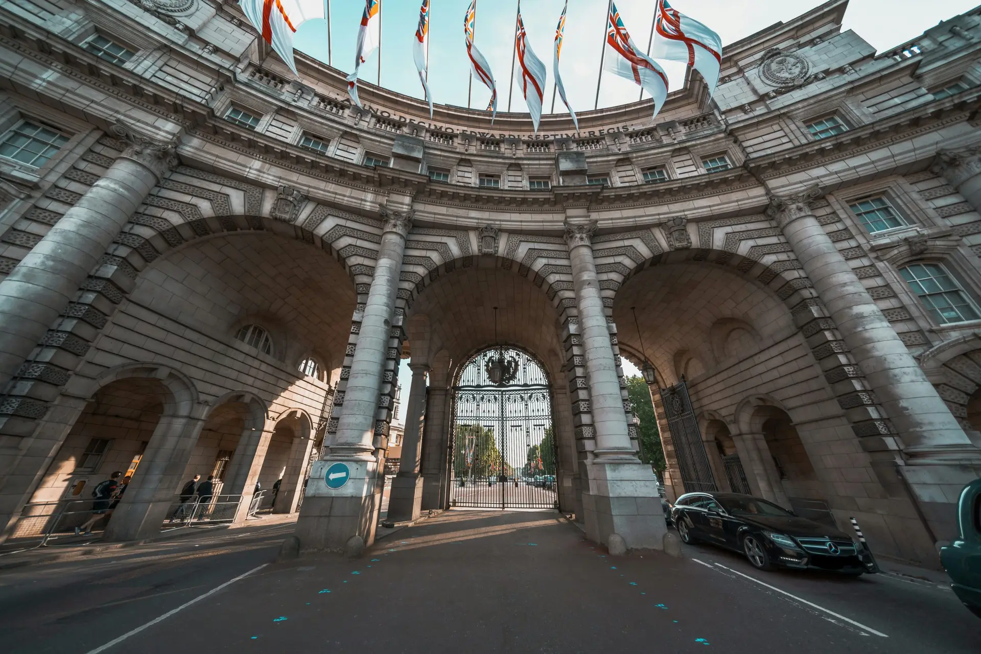 Admiralty Arch in London with British naval flags, the Grade I-listed Edwardian monument that becomes Waldorf Astoria London in 2026