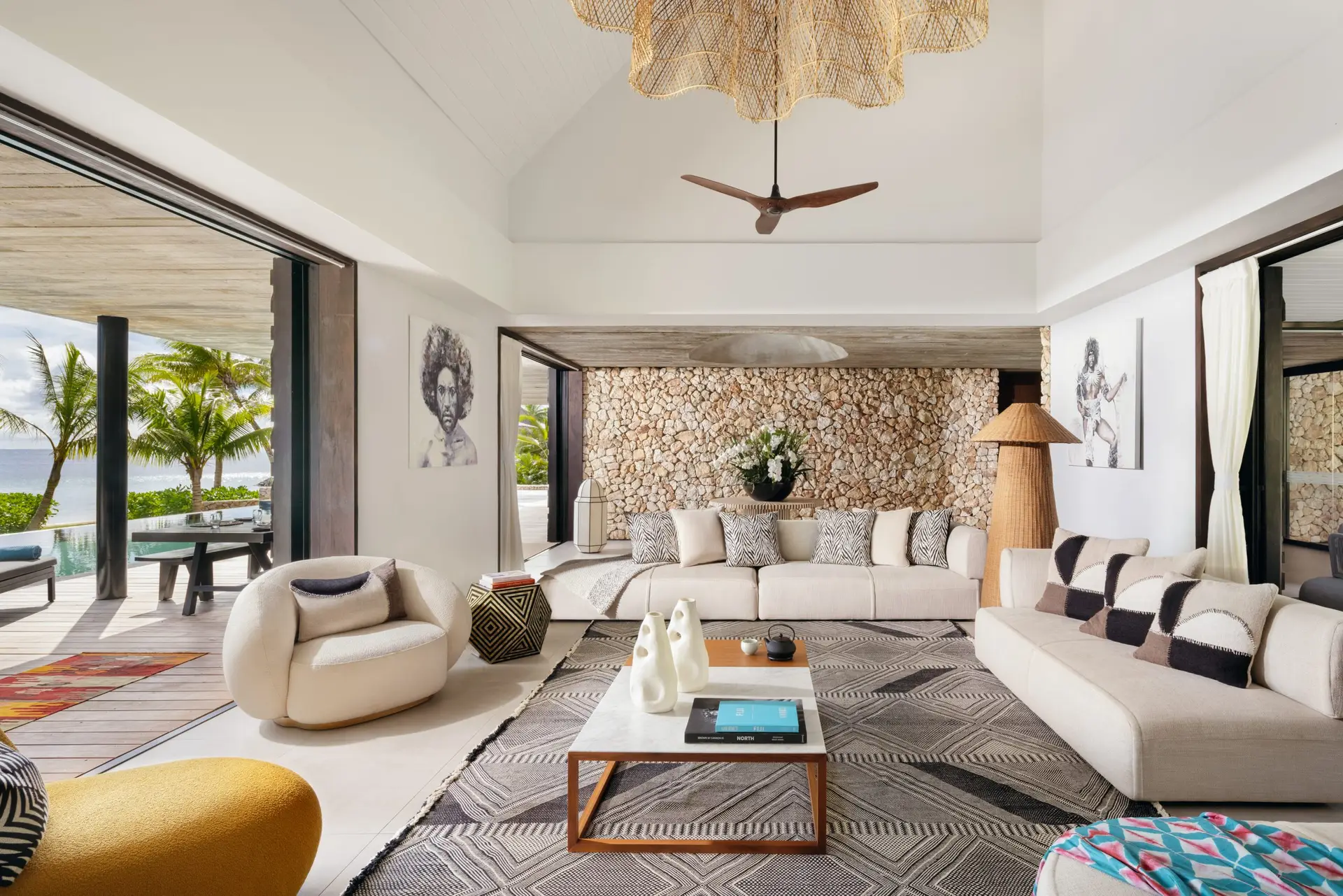 Six Senses Fiji Opens Three Beachfront Residences on Malolo Island 2 Living room interior at a Six Senses Fiji Residence on Malolo Island, with stone wall, open layout and ocean view