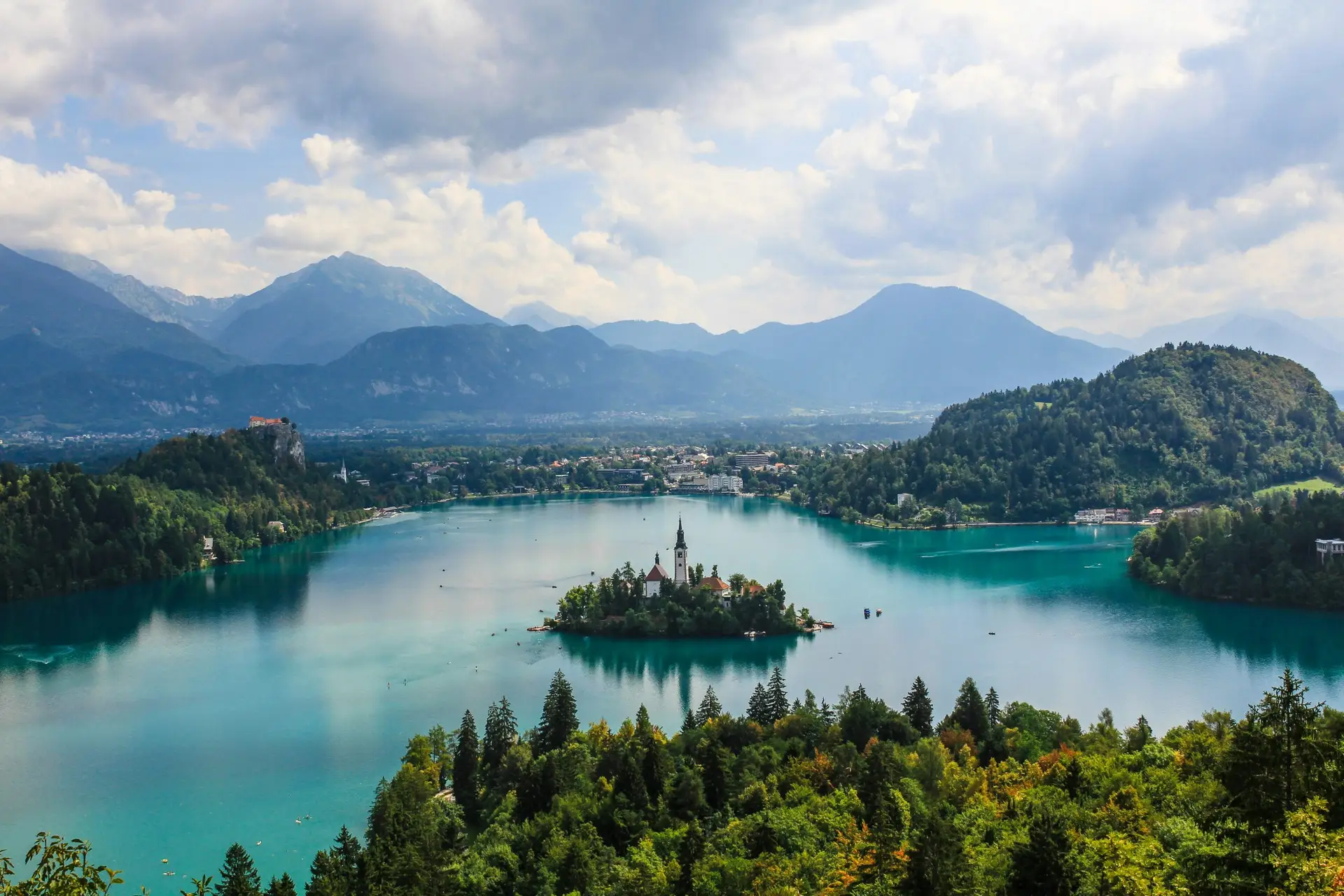 Solo travel destinations 2026: Lake Bled in Slovenia, with Bled Castle on the cliff and the Pilgrimage Church on the island, set against the Julian Alps in one of Europe's most underrated solo destinations
