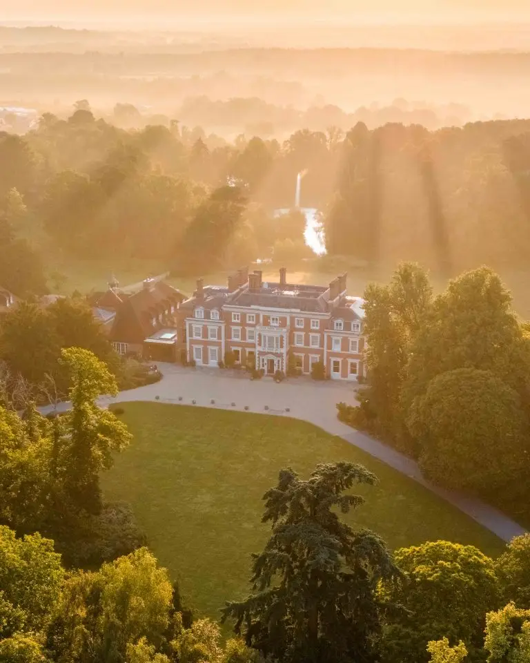 Farm-to-table luxury hotels 2026 - Heckfield Place aerial view at sunrise Hampshire