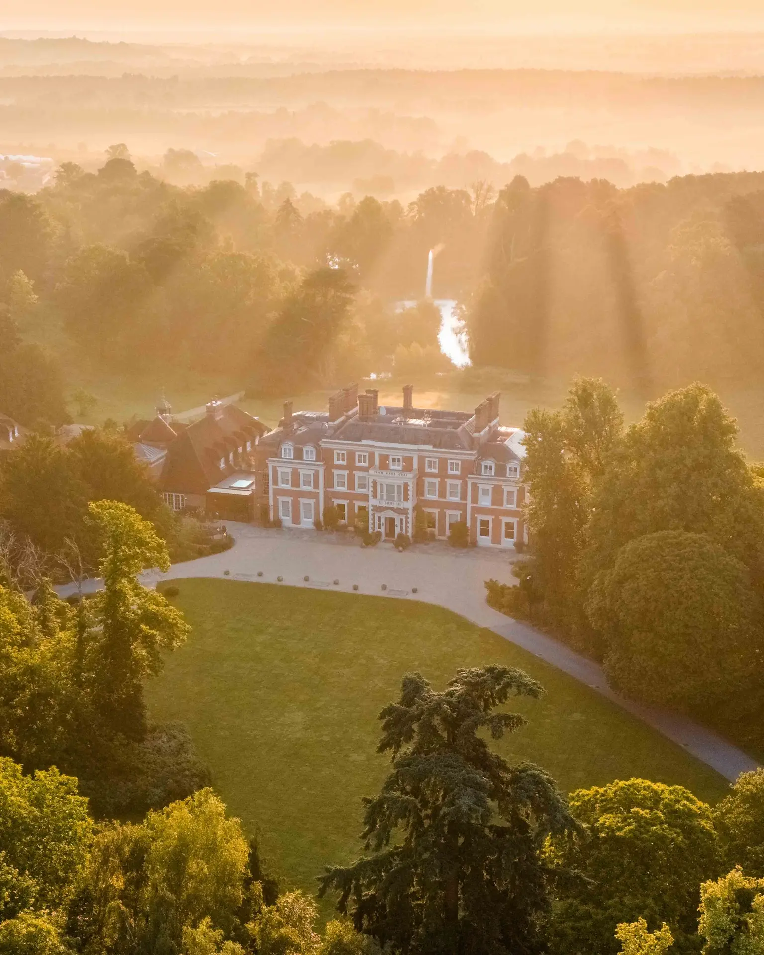 Farm-to-table luxury hotels 2026 - Heckfield Place aerial view at sunrise Hampshire