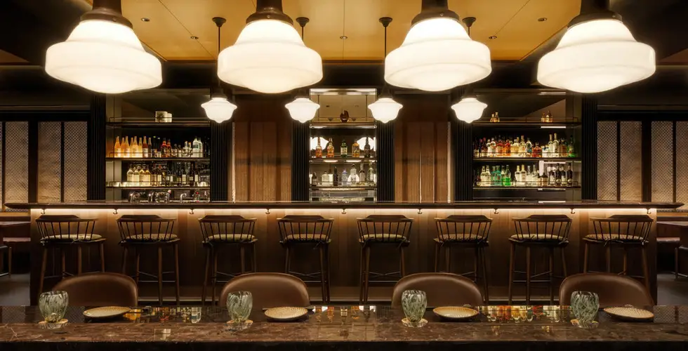 Capella Kyoto Review 2026: Inside Japan's Most Anticipated Luxury Opening 14 Yoi bar at Capella Kyoto with schoolhouse pendant lamps and marble counter