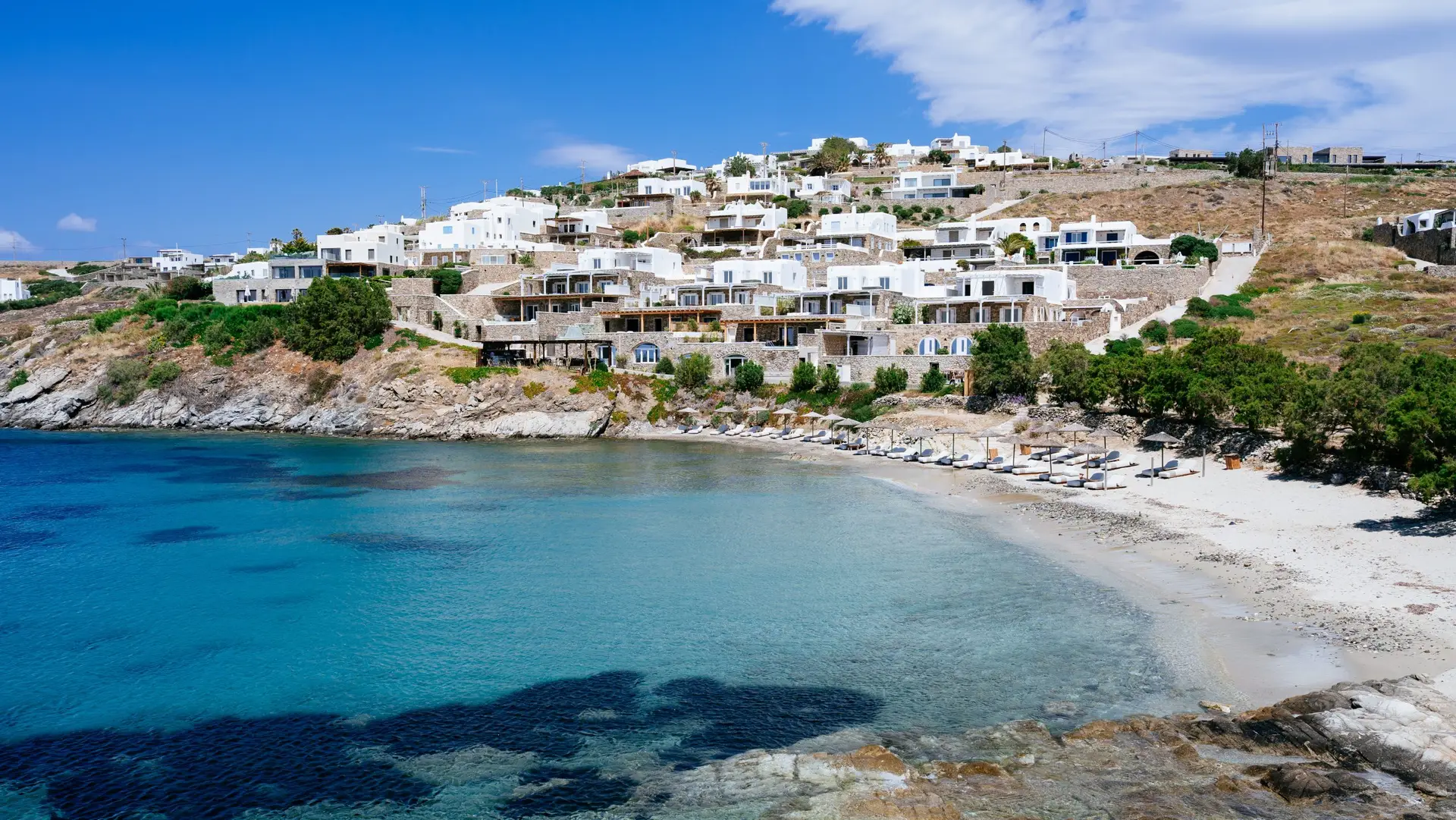 Casa Del Mar Mykonos: A Week on the Quiet Side of the Island 3 Casa Del Mar Mykonos stepping down the Aleomandra hillside above Glyfadi cove, with the villas, the beach and clear turquoise water on the island's southwest coast