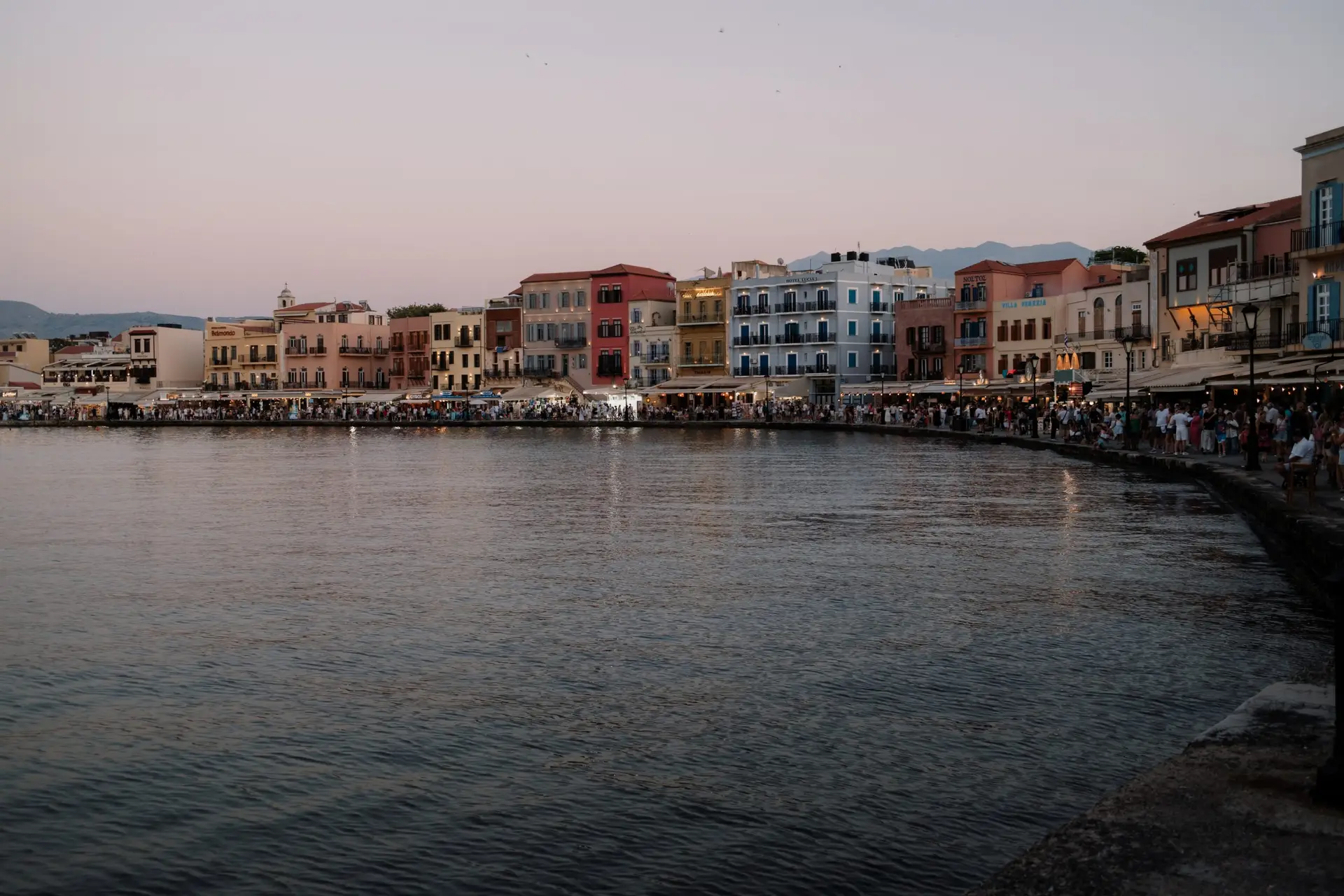 JW Marriott Crete Resort & Spa: The Complete Guide to Greece’s First JW Marriott 14 Pastel-coloured buildings along the Venetian harbour in Chania Old Town at dusk, a short drive from JW Marriott Crete