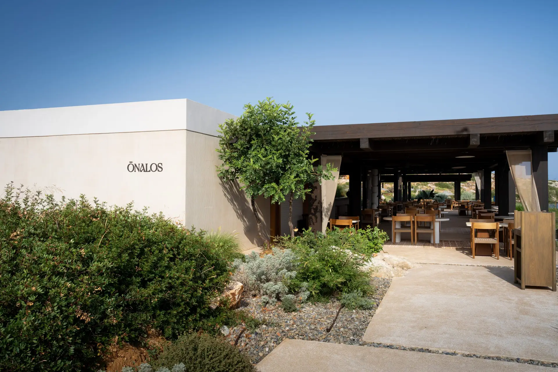 JW Marriott Crete Resort & Spa: The Complete Guide to Greece’s First JW Marriott 10 Entrance to Ōnalos seafood restaurant at JW Marriott Crete, an open pavilion with wooden tables looking out to the sea