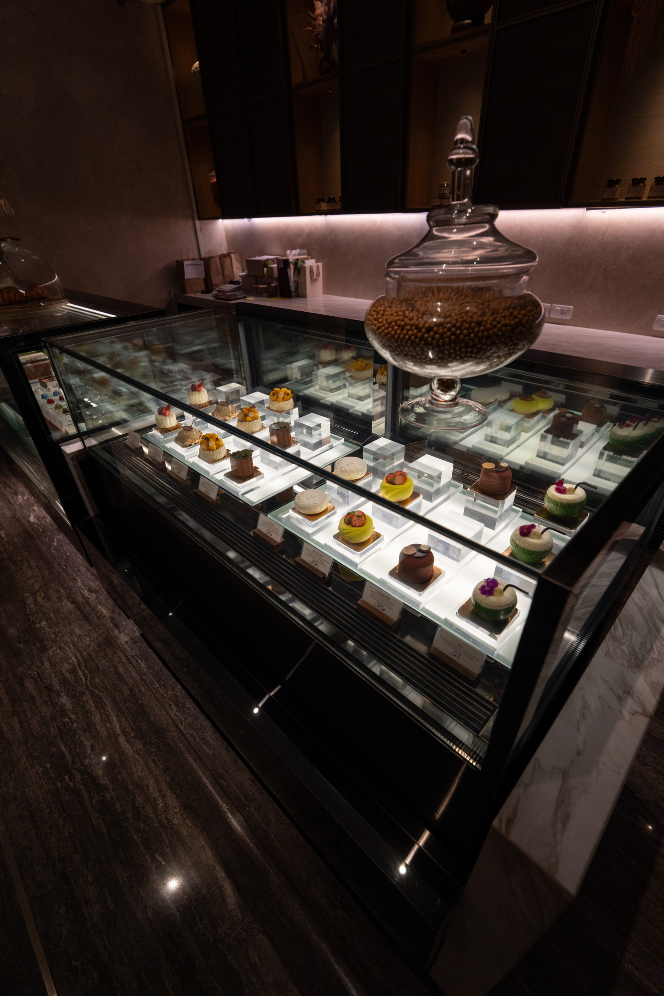 Cakes and pastries in the display at Kin patisserie, Capella Bangkok