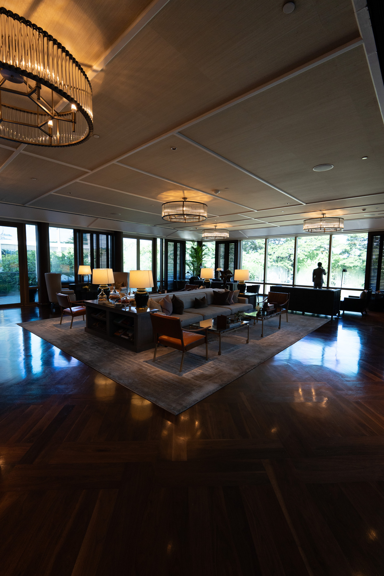 The Living Room at Capella Bangkok with chandeliers and tall windows