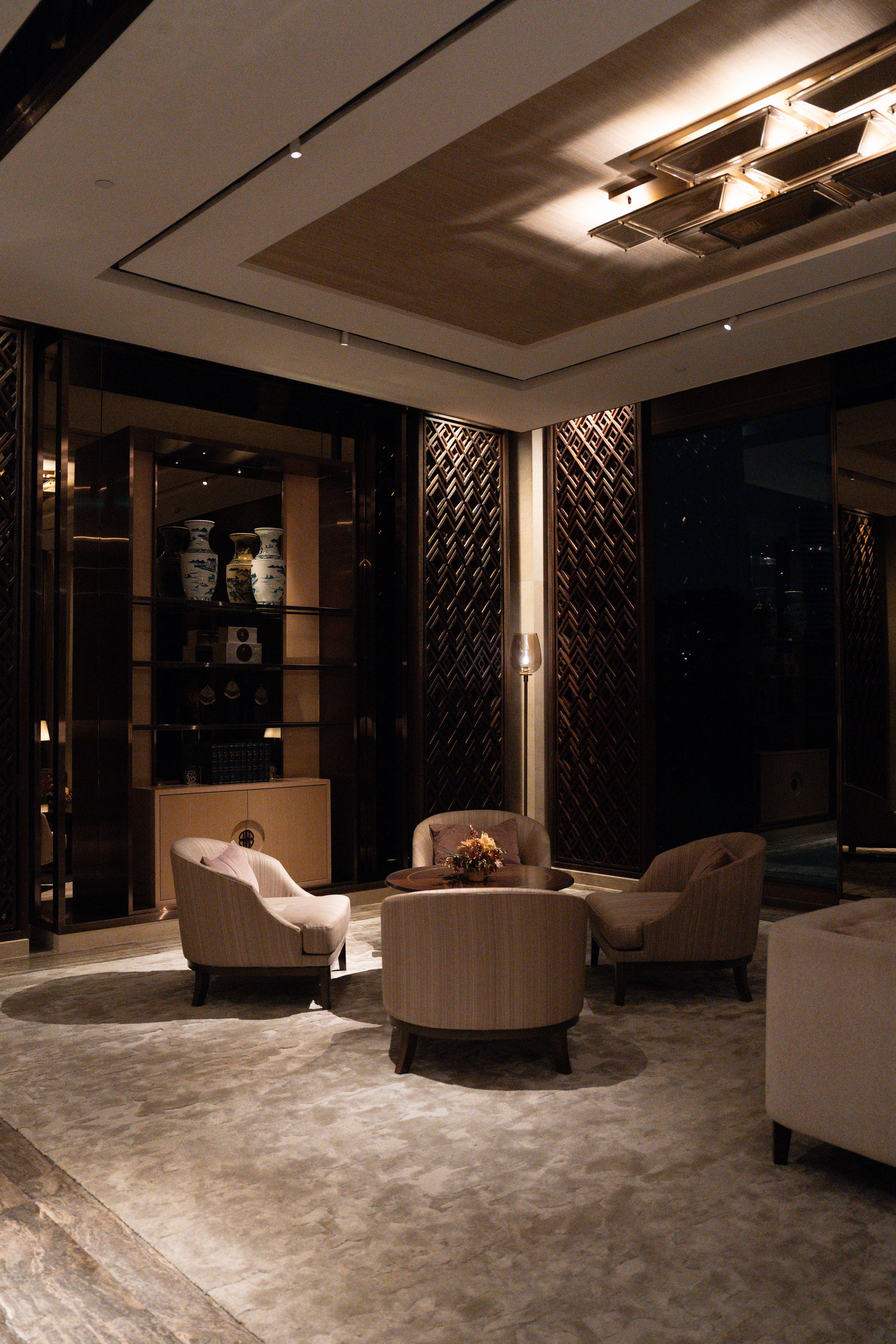 Armchairs in the lobby lounge at Capella Bangkok in the evening