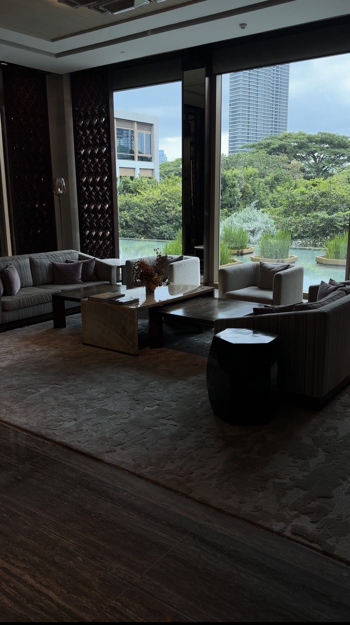 Lobby seating area looking out over still water at Capella Bangkok