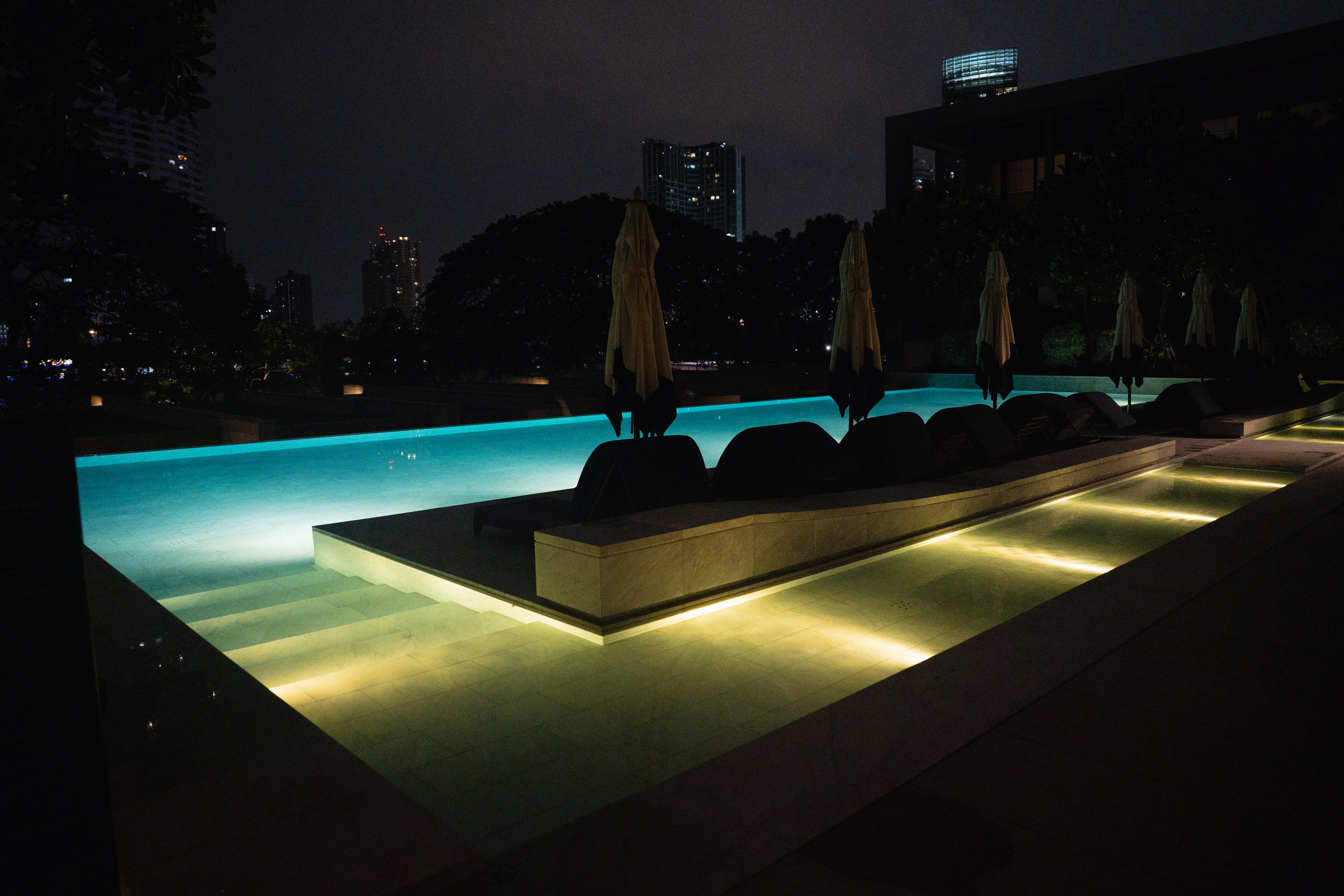Capella Bangkok pool lit up at night