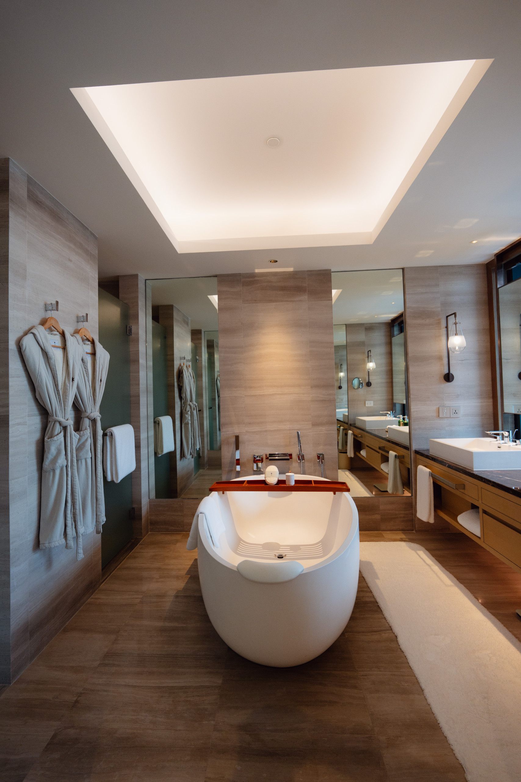Freestanding bathtub and double vanity in a Riverfront Premier bathroom at Capella Bangkok