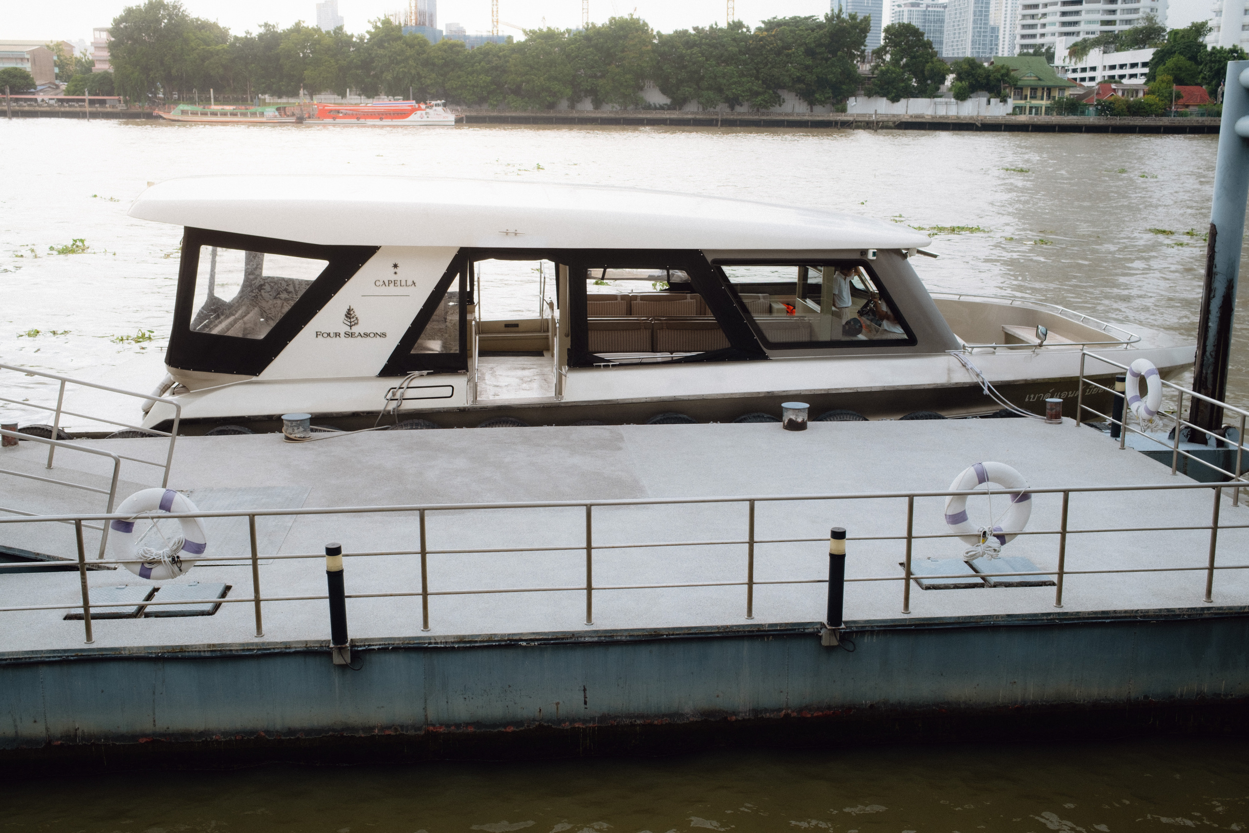 Shuttle boat at the pier on the Chao Phraya River at Capella Bangkok