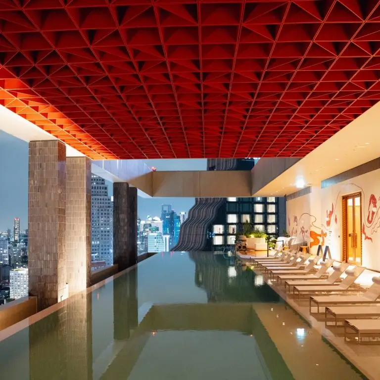KROMO Bangkok rooftop infinity pool red ceiling skyline