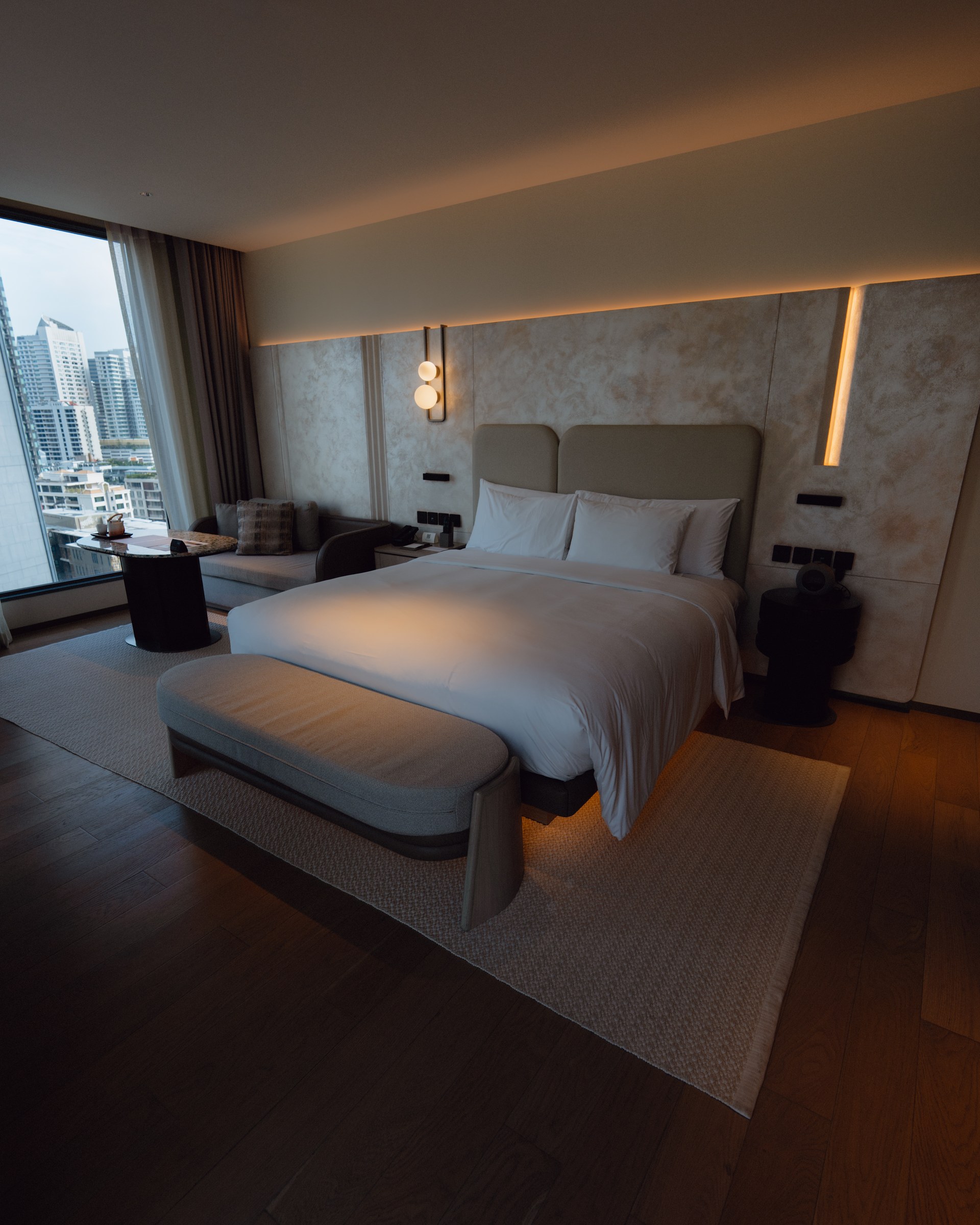 KROMO Bangkok Corner Junior Suite bedroom with city view