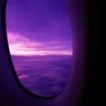 Thai Airways Amsterdam to Bangkok: purple sky above the clouds seen from the A350 window