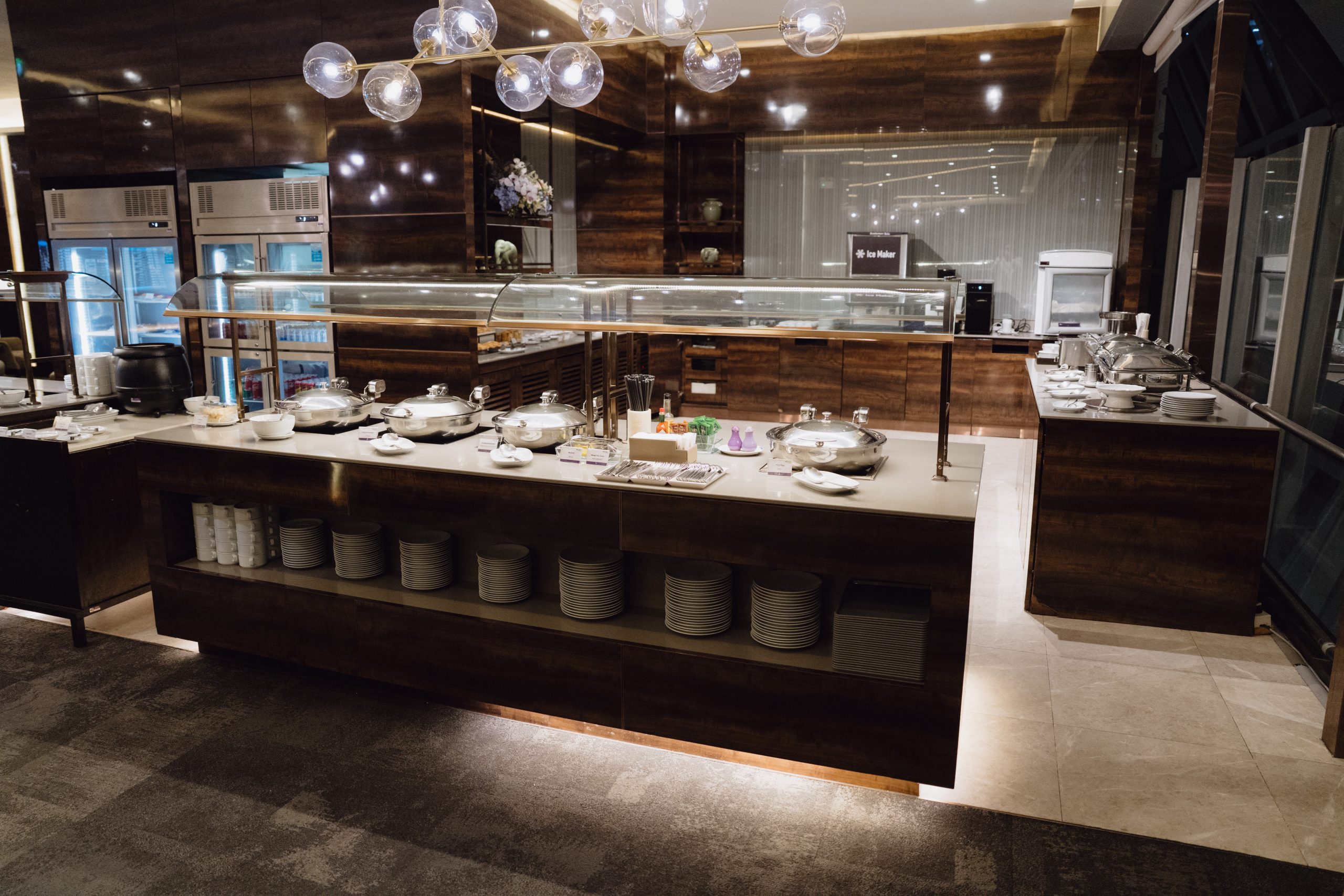 Thai Airways Amsterdam to Bangkok: a Royal Silk review of the new daily flight 10 Hot buffet station with covered dishes, plates and drinks fridges in the Thai Airways Royal Orchid Prestige Lounge at Bangkok Suvarnabhumi