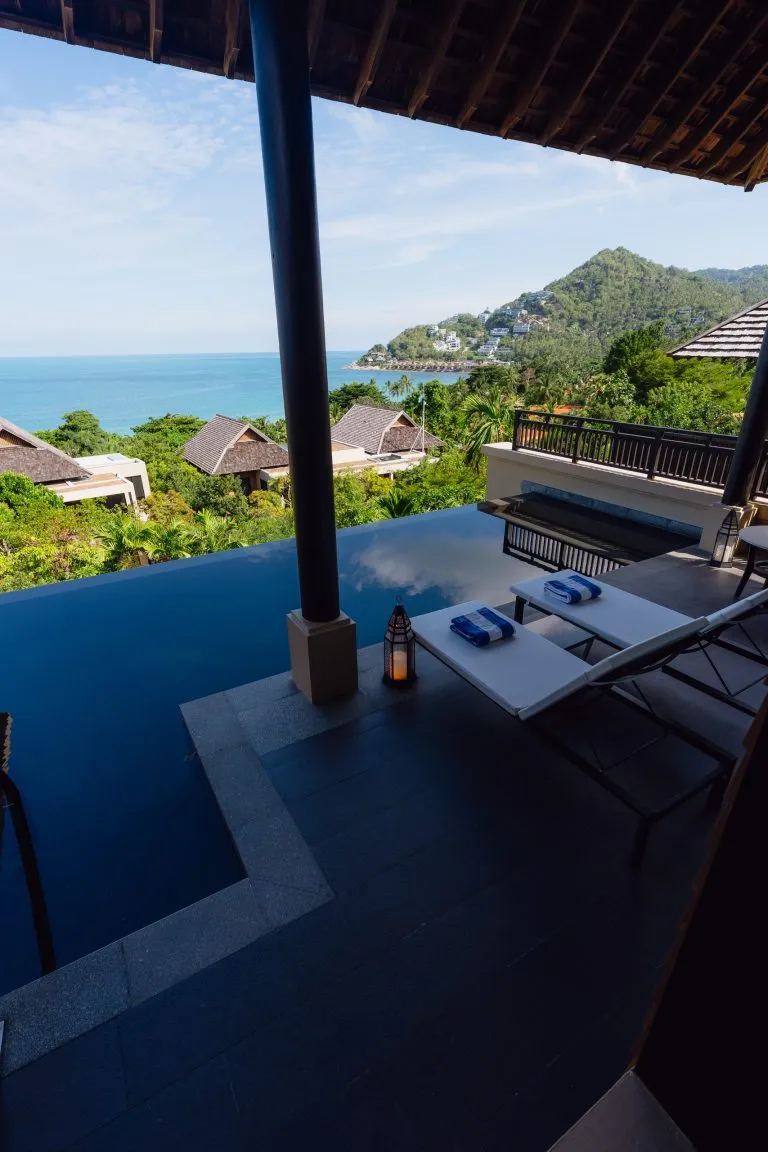 Private infinity pool and loungers on the Grand Pool Suite terrace at Vana Belle Koh Samui, looking over the jungle to the sea